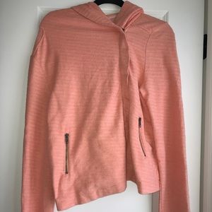 Peach colored, side zipped sweatshirt.